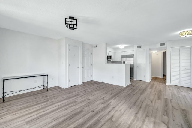 unfurnished living room featuring light hardwood / wood-style flooring