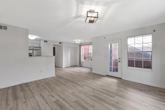 unfurnished living room featuring light hardwood / wood-style flooring