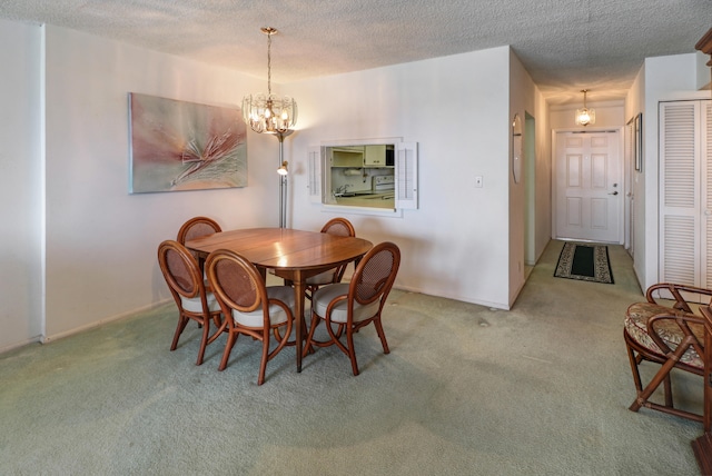 carpeted dining room featuring an inviting chandelier and a textured ceiling