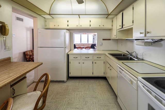 kitchen featuring white appliances, sink, and white cabinets