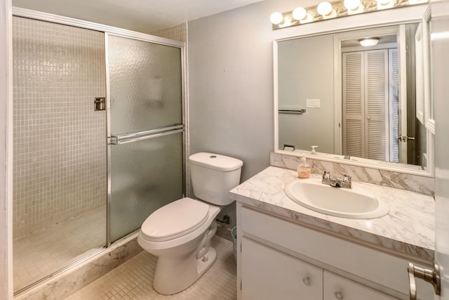 bathroom featuring tile patterned floors, vanity, walk in shower, and toilet