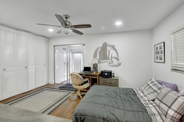 bedroom with ceiling fan, a closet, and hardwood / wood-style flooring