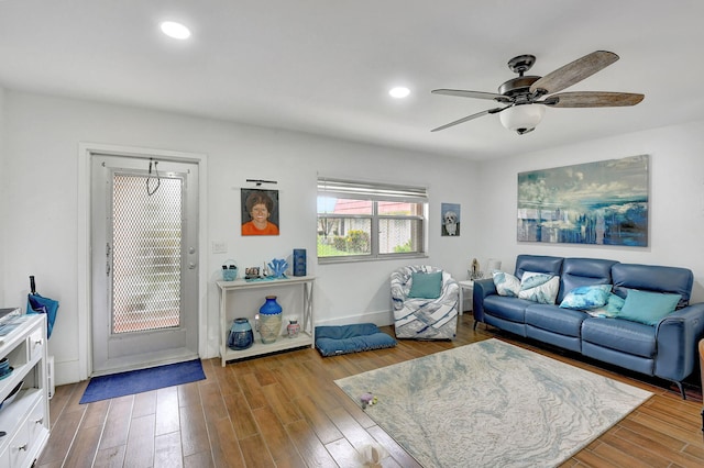 living room featuring light wood-type flooring and ceiling fan