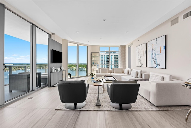 living room featuring light hardwood / wood-style floors and expansive windows