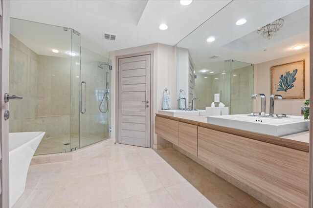 bathroom featuring independent shower and bath, vanity, and tile patterned flooring