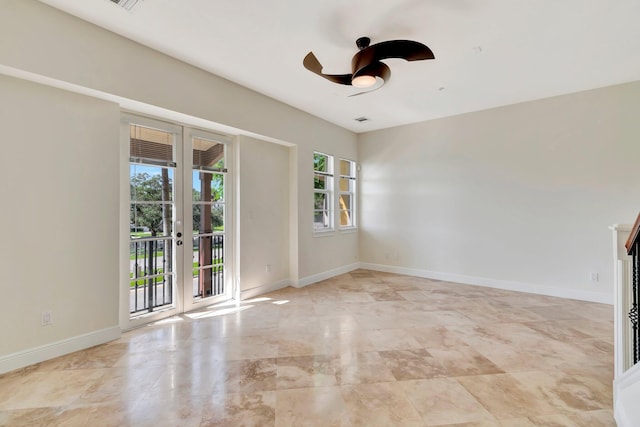 empty room with ceiling fan and french doors