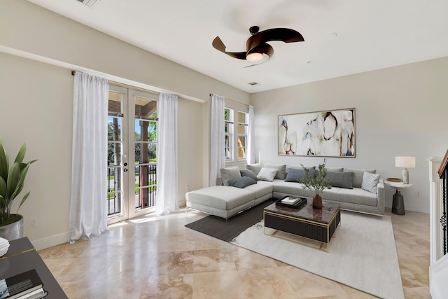 living room featuring ceiling fan and french doors