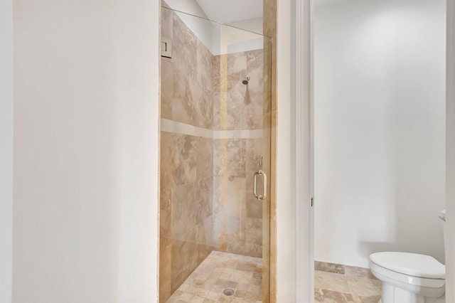 bathroom featuring walk in shower and toilet