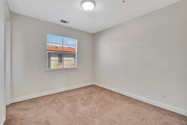 spare room with light colored carpet