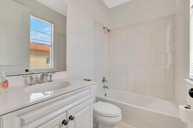 full bathroom featuring tile patterned floors, tiled shower / bath, vanity, and toilet