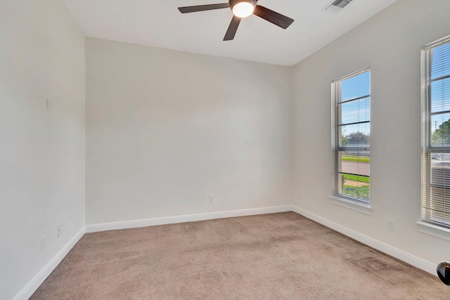 carpeted spare room with ceiling fan