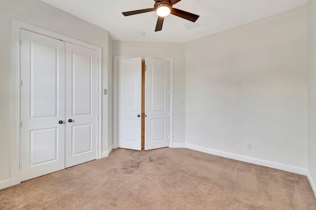 unfurnished bedroom featuring ceiling fan and light colored carpet