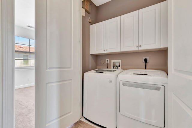 laundry room featuring cabinets, light colored carpet, and separate washer and dryer