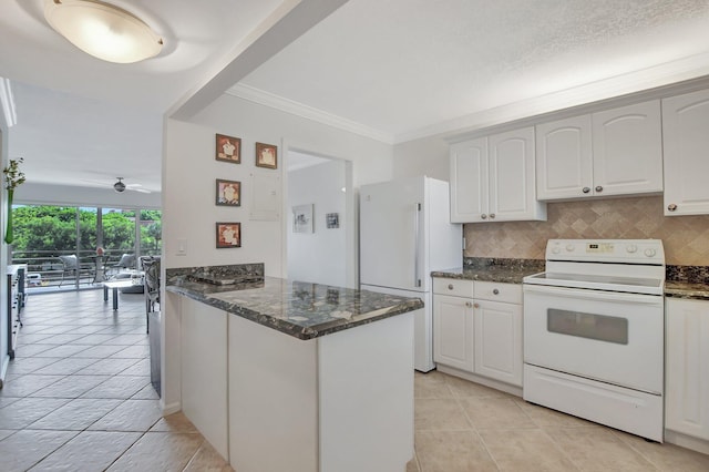 kitchen with decorative backsplash, white appliances, kitchen peninsula, and white cabinetry