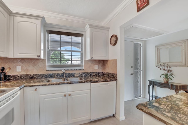 kitchen with white cabinets, sink, white appliances, and tasteful backsplash