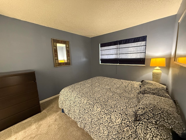 bedroom featuring carpet floors and a textured ceiling