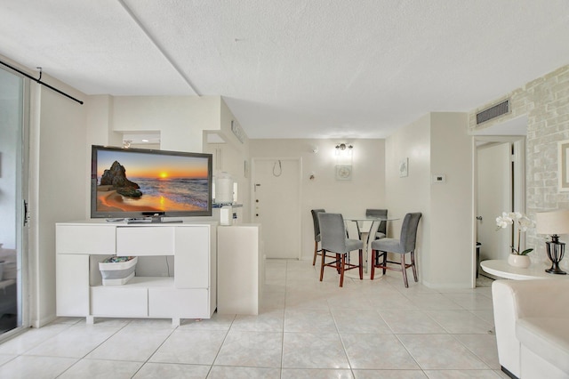 tiled living room with a textured ceiling