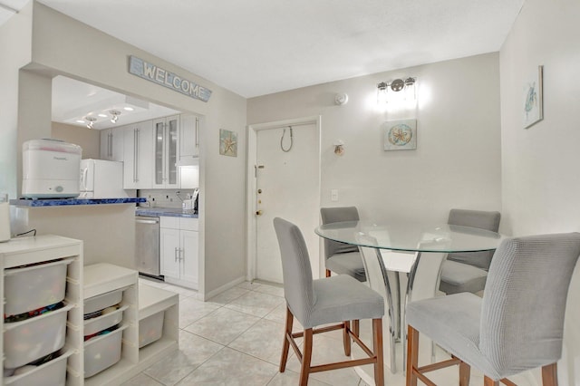 dining area with light tile patterned floors