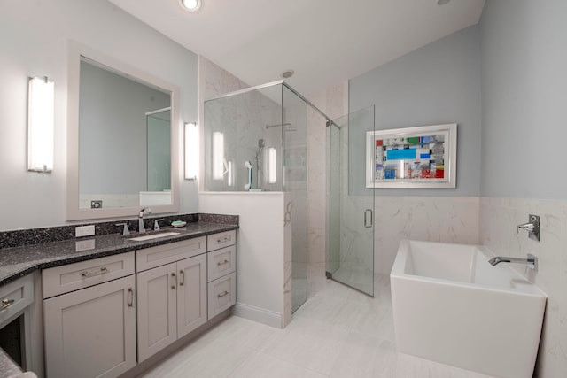 bathroom with tile patterned floors, vanity, and separate shower and tub