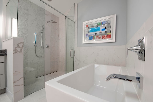 bathroom featuring vanity and separate shower and tub