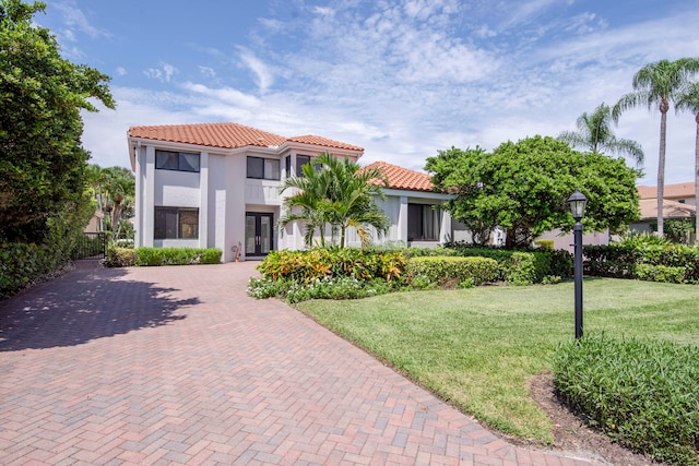 mediterranean / spanish house with a front yard