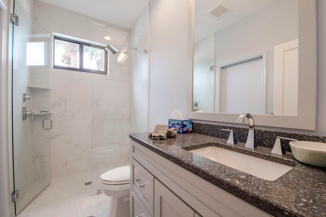 bathroom featuring vanity, a shower with shower door, toilet, and tile patterned floors