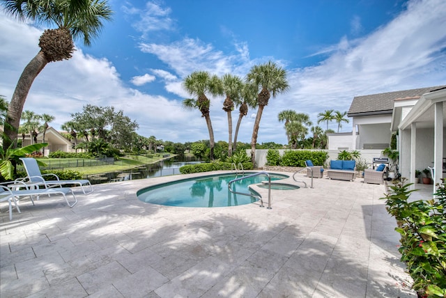 view of pool with a water view and a patio area