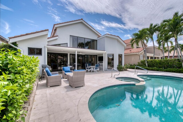 view of swimming pool featuring a patio, an in ground hot tub, and an outdoor hangout area