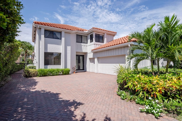 mediterranean / spanish-style home with a garage