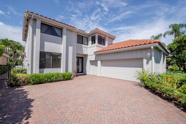 mediterranean / spanish home with a garage