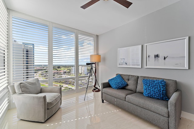 living room with tile patterned flooring, ceiling fan, and a wealth of natural light