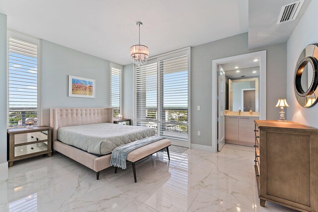 bedroom with a chandelier and ensuite bathroom