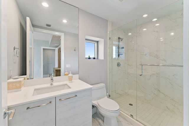 bathroom featuring vanity, toilet, and an enclosed shower