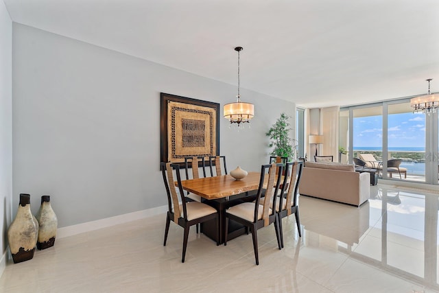 dining space with a water view, a chandelier, and light tile patterned floors