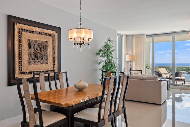 tiled dining area with a notable chandelier and a water view