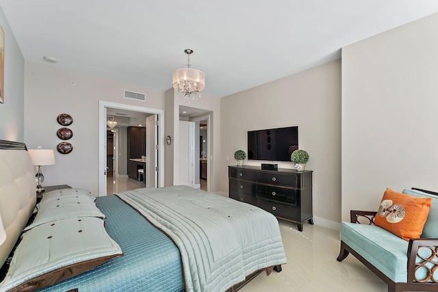 bedroom with connected bathroom and a notable chandelier