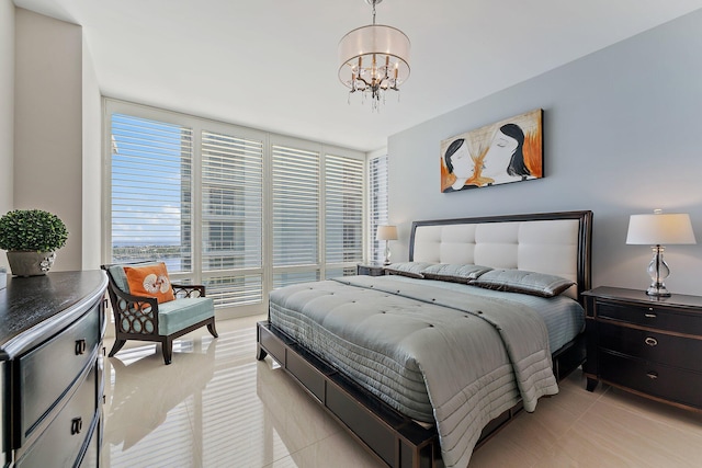 tiled bedroom with a wall of windows and a chandelier