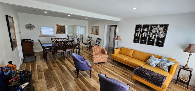 living room featuring wood-type flooring and beam ceiling