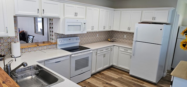 kitchen featuring white cabinets, white appliances, dark hardwood / wood-style floors, and sink