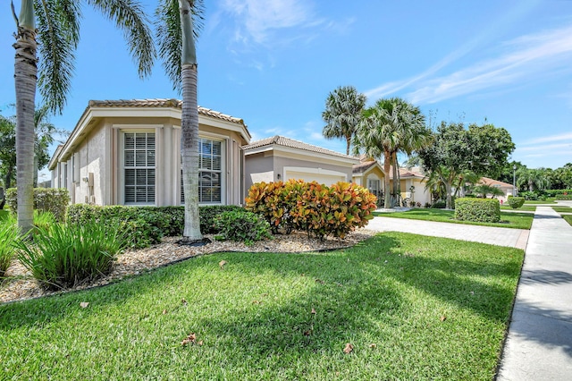 view of side of home with a lawn