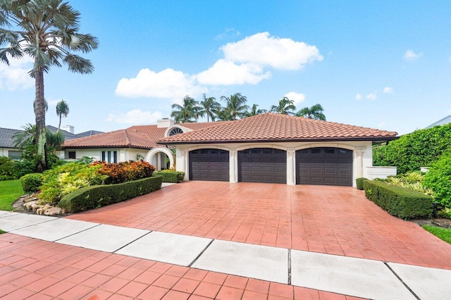 mediterranean / spanish house with a garage