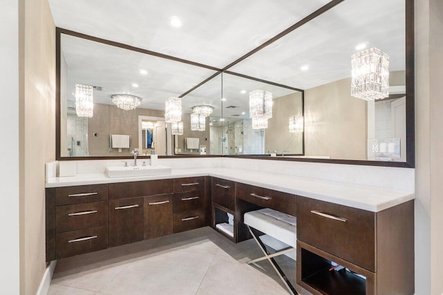 bathroom featuring a notable chandelier, tile patterned flooring, a shower, and vanity