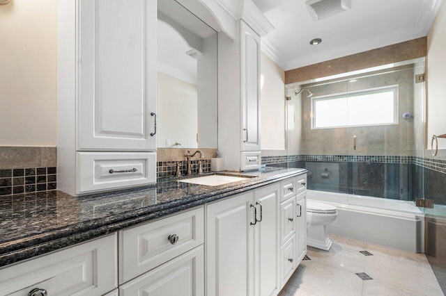 full bathroom with tile patterned floors, crown molding, vanity, enclosed tub / shower combo, and toilet