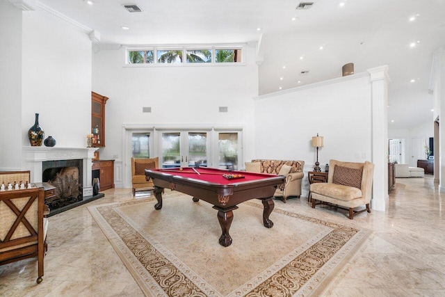 game room with ornamental molding, a towering ceiling, billiards, and french doors