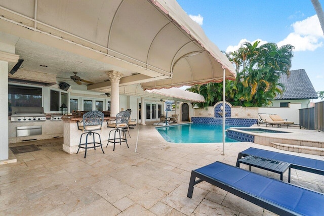 view of pool with an outdoor kitchen, a patio area, area for grilling, an in ground hot tub, and ceiling fan