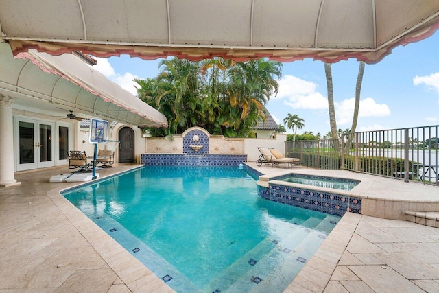 view of swimming pool featuring a patio, an in ground hot tub, and french doors