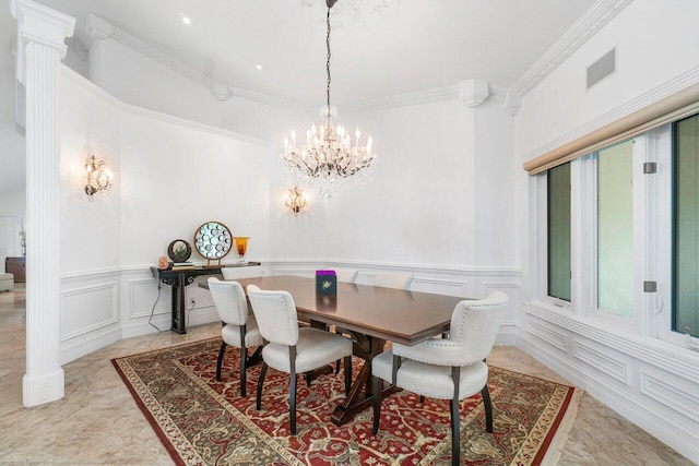 dining area with crown molding and a chandelier