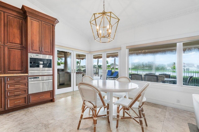 dining area with a healthy amount of sunlight, lofted ceiling, crown molding, and an inviting chandelier