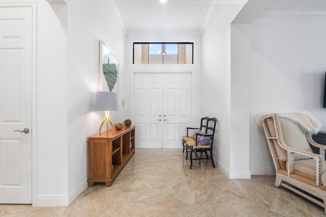 entryway with a textured ceiling and crown molding