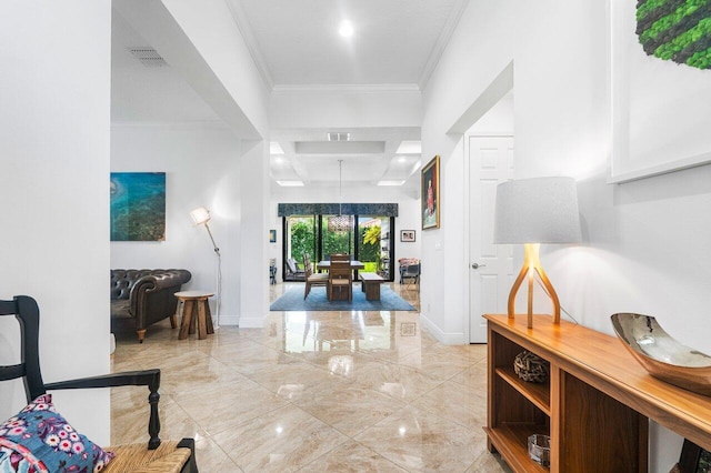 entrance foyer featuring an inviting chandelier and crown molding